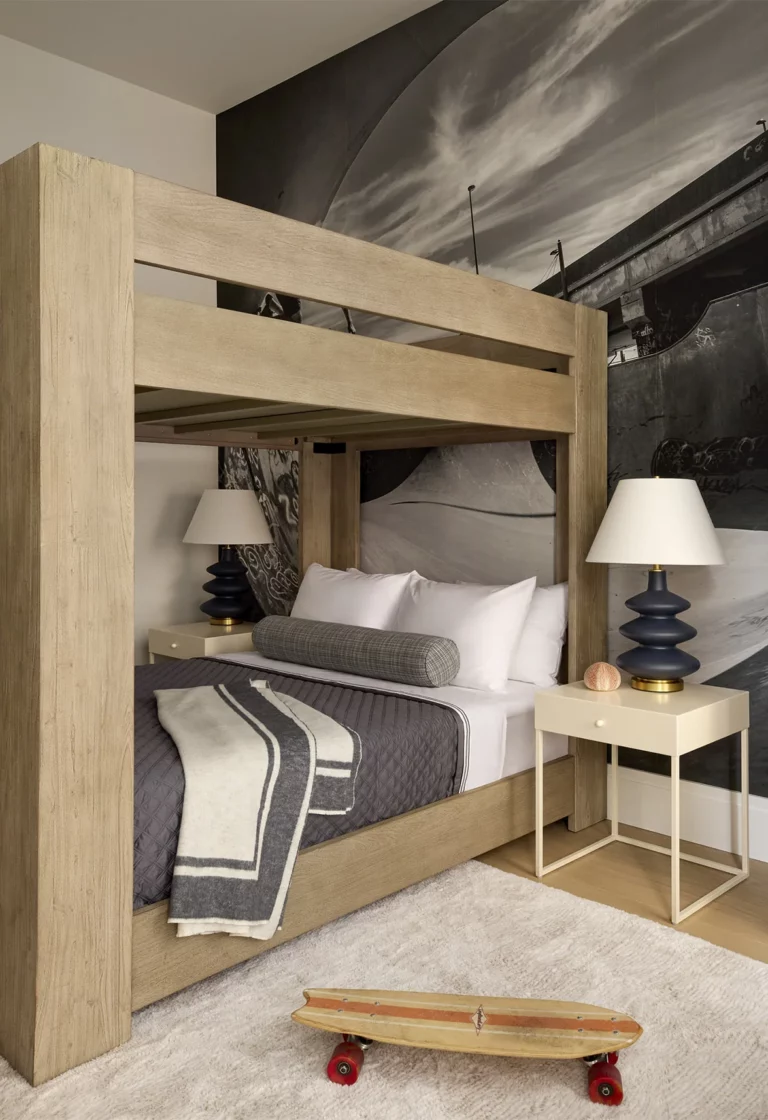 Boys bedroom in a Snøhetta Upper West Side apartment with a wood canopy bed, graphic mural wall, and sculptural bedside lamps.
