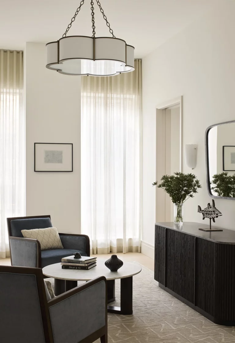 Bedroom vestibule in a Snøhetta Upper West Side residence with a small seating area, sculptural credenza, and soft filtered daylight from tall windows.