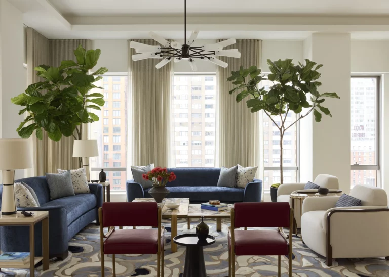 Lounge seating area in a Snøhetta Upper West Side apartment with tall windows, layered seating, and abundant daylight designed for family gatherings and entertaining.